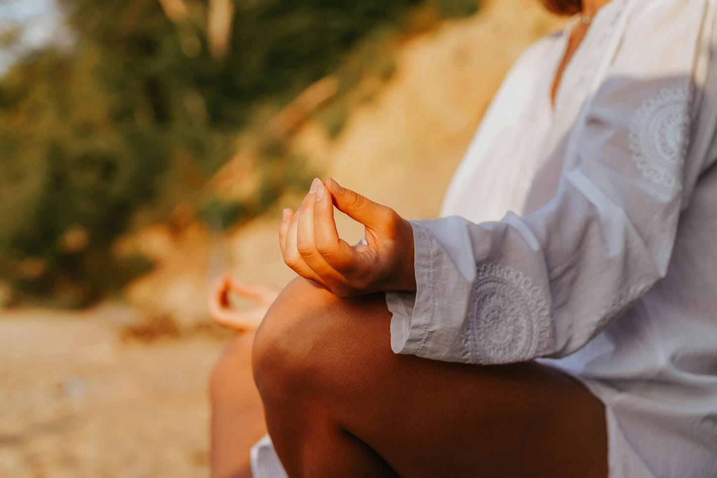 Woman sitting outdoors, in a meditative position. Woman sitting outdoors, in a meditative position.