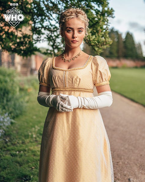Pics 1 and 2 L-R: Jonathan Groff, Millie Gibson and Ncuti Gatwa on set for the upcoming series of Doctor Who. They are wearing regency-style clothing and standing together in the stairwell of an old manor. Pics 3-5 are additional pics of Gibson in a garden wearing a gold-coloured regency style dress with elbow-length white gloves.