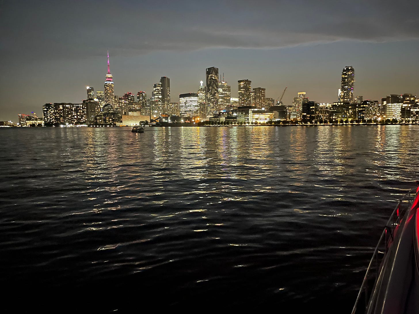 A photo of the Toronto city skyline, taken from the water at dusk A photo of the Toronto city skyline, taken from the water at dusk