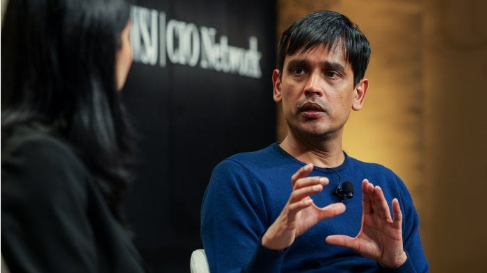 Srinivas Narayanan of OpenAI speaking at a summit.