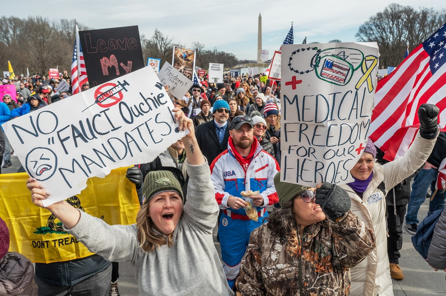 2021 Washington DC protest of vaccines, including signs that say "No Fauci Ouchie Mandates" and "Medical Freedom For Our Heroes," in an almost entirely white crowd