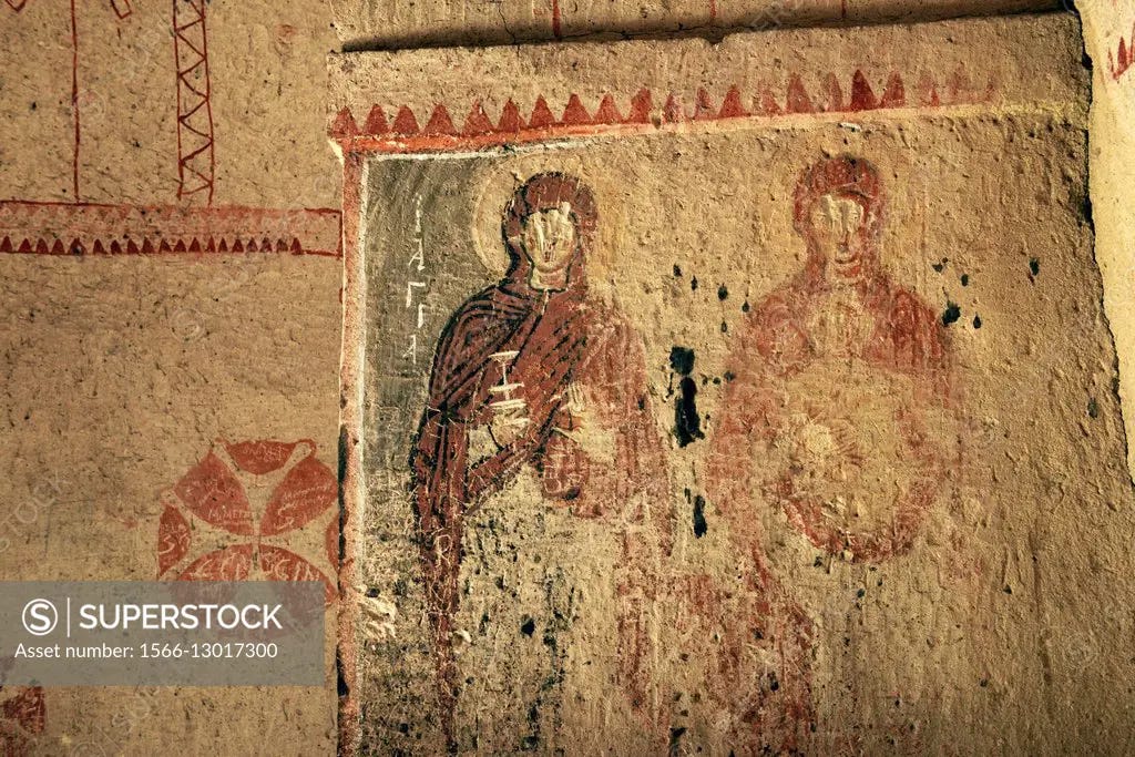 Early Christian mural. Saints, defaced gouged eyes, in rock ...