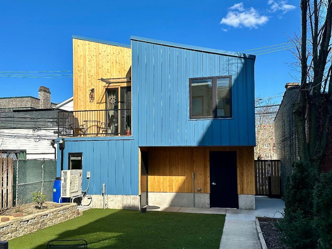 A blue and brown house with a lawn

AI-generated content may be incorrect.