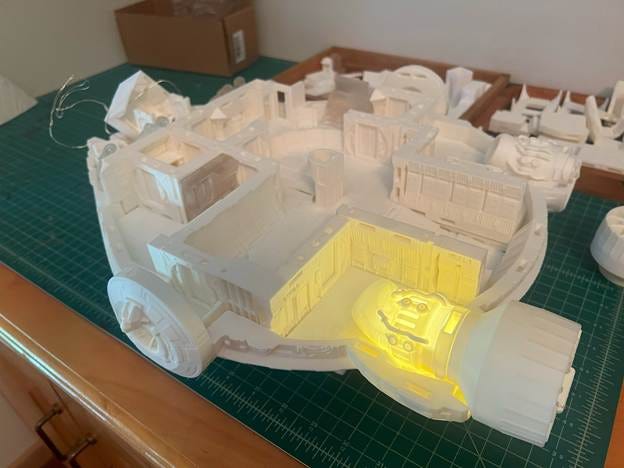 A model of a building on a table

AI-generated content may be incorrect.