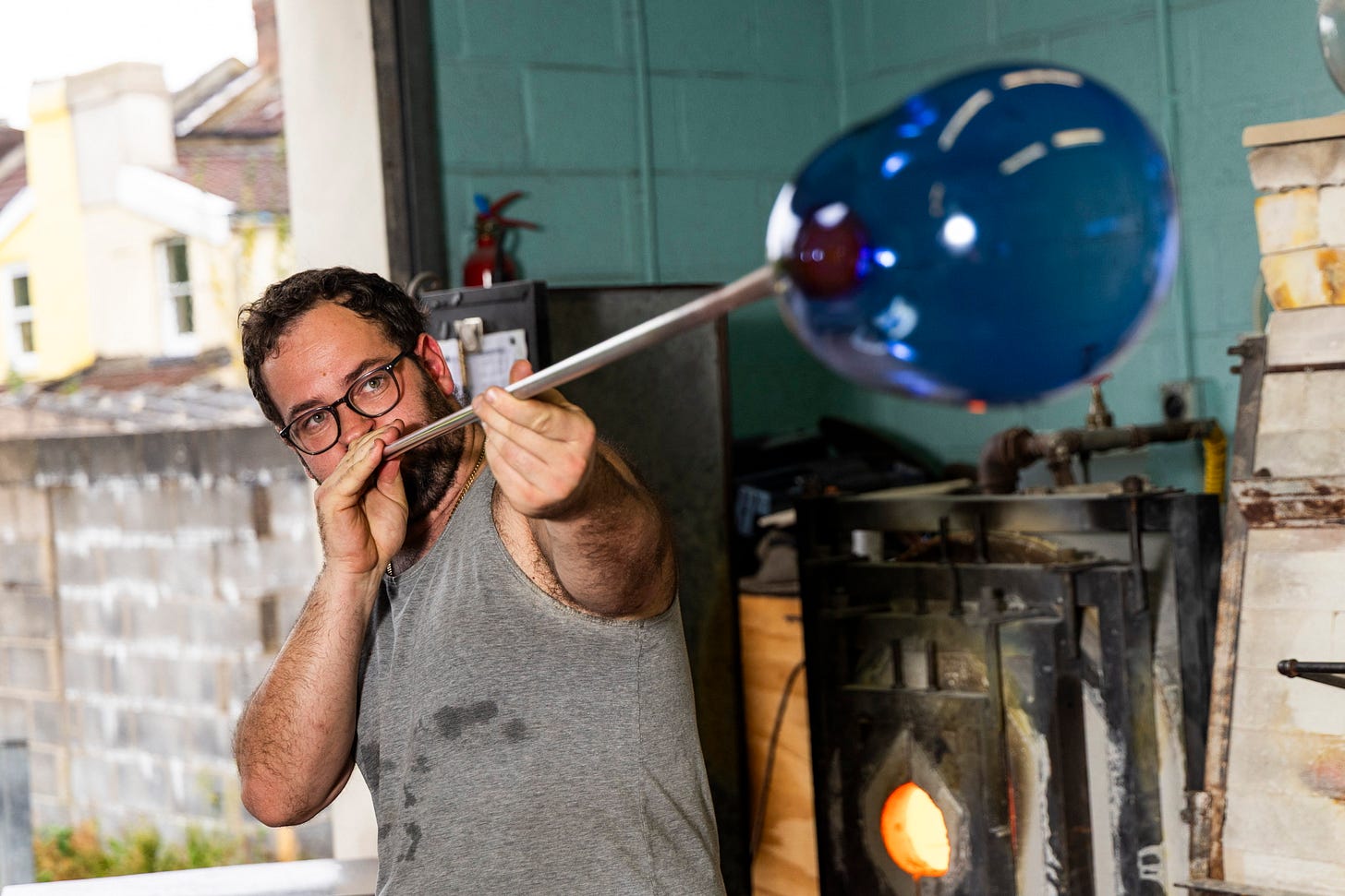 David Barry from Bristol Blue Glass blowing a glass shape