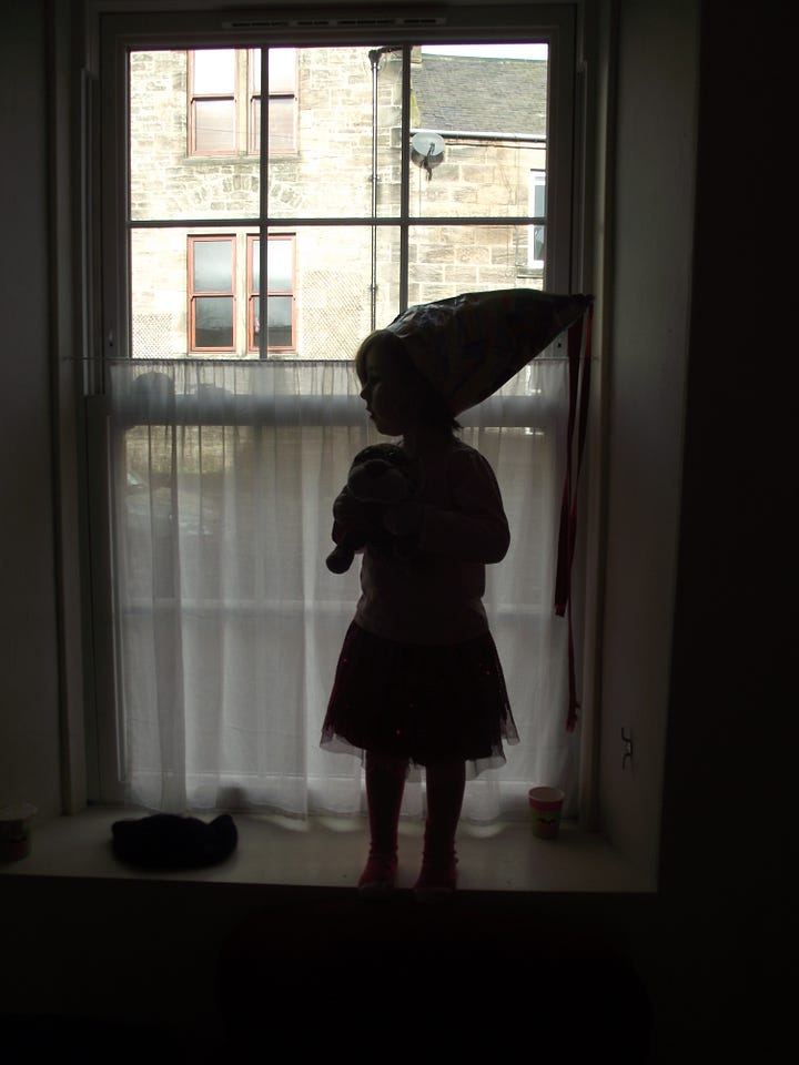 Picture of toddler standing in a window and Helen and Pie at their front door when Pie was about 4 years old
