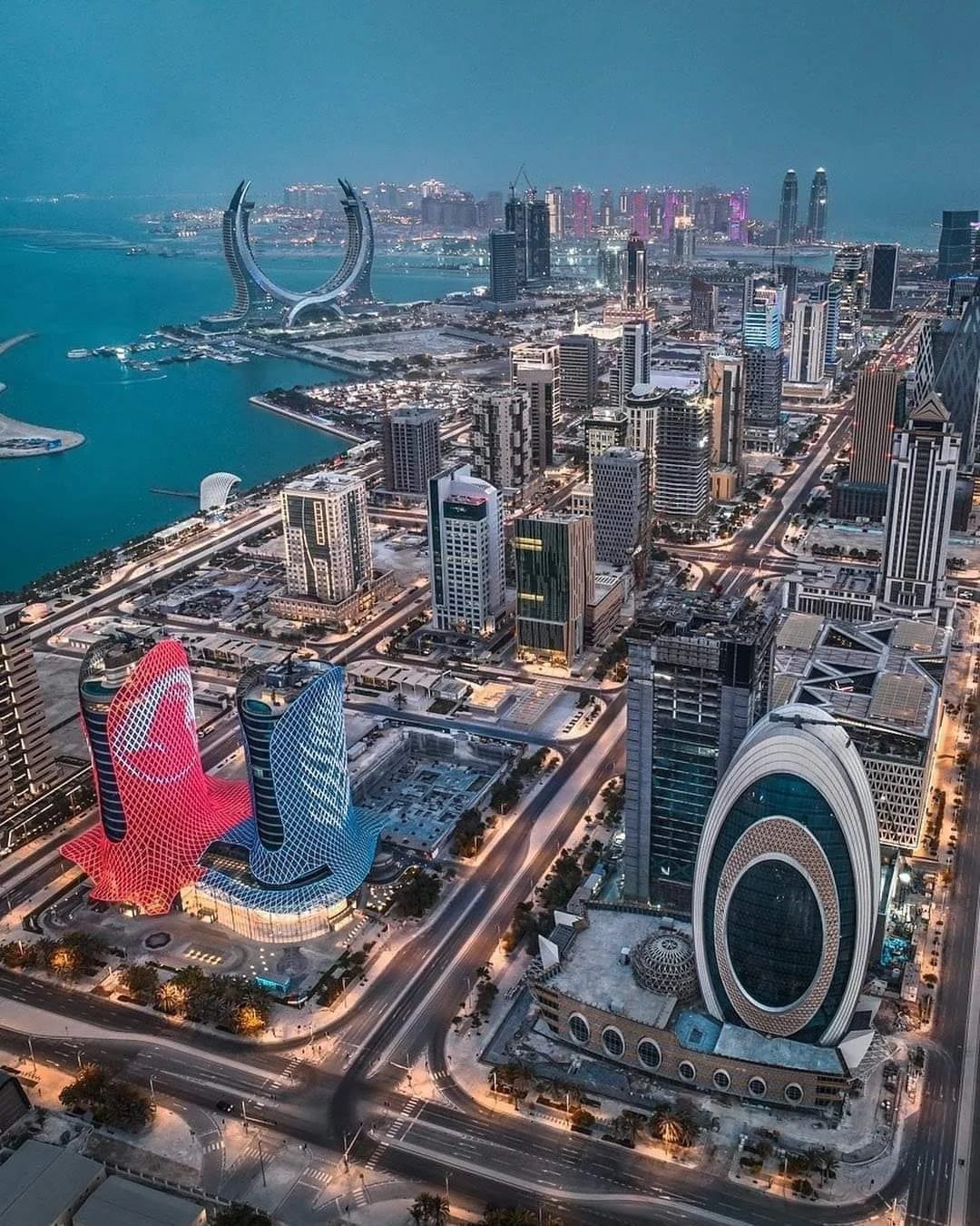 Aerial view of Doha's skyline showcasing luxury real estate development and iconic buildings associated with Qatar's booming property market