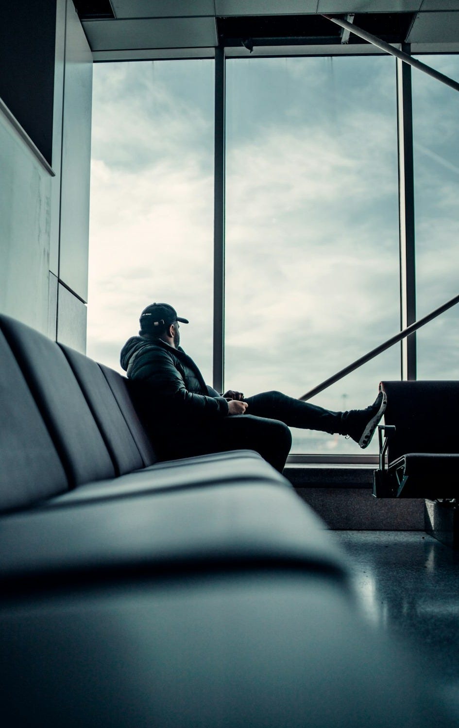 man in black jacket sitting on train seat man in black jacket sitting on train seat