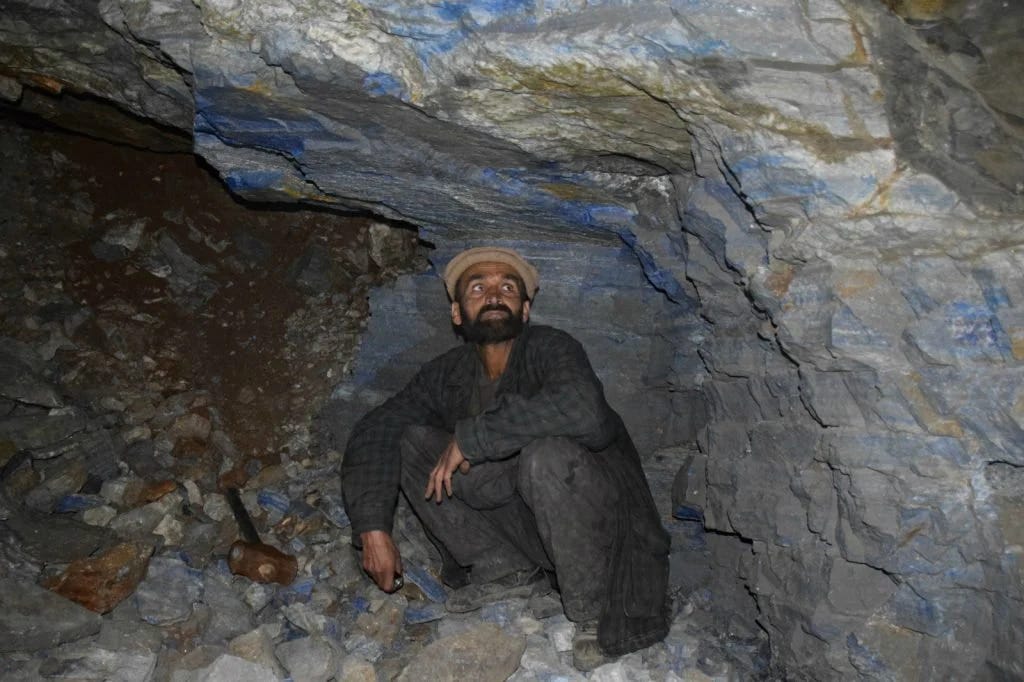 Miner in a hand-dug and blasted mine at Sar-e-Sang Miner in a hand-dug and blasted mine at Sar-e-Sang