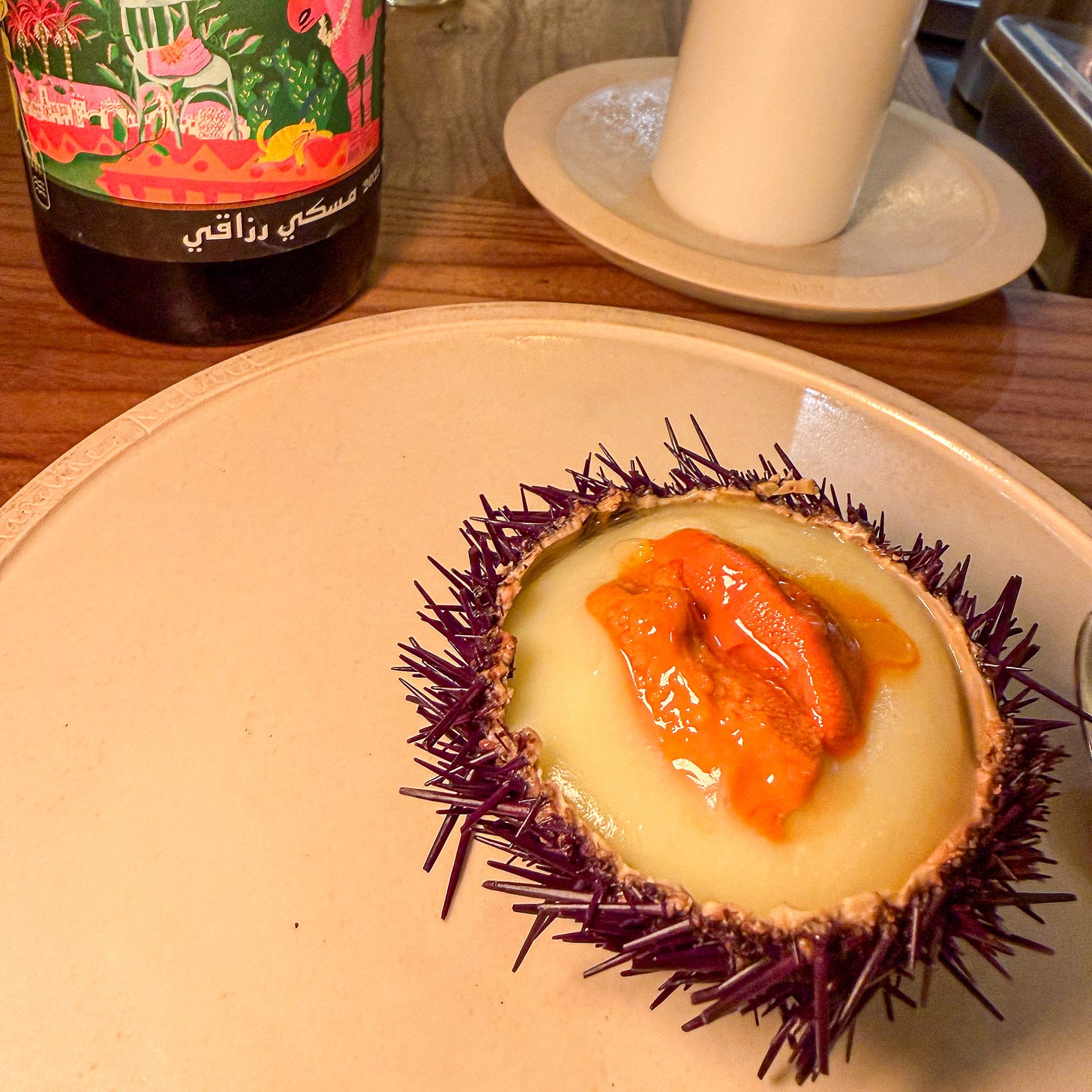 Sea urchin in shell with potato sauce alongside Tunisian wine at Masaikuta, Paris 11th