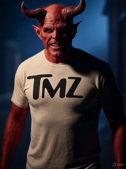 A person with red skin, horns, and pointed ears, resembling a devil, wearing a beige T-shirt with "TMZ" in black letters. The background is dark blue with indistinct shapes.