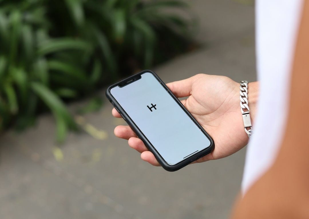 a person holding a cell phone in their hand