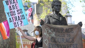 Protestors at the Millicent Fawcett statue holding signs that read "What are you so afraid of?" and "Fag Rights Calls to Courage Everywhere".