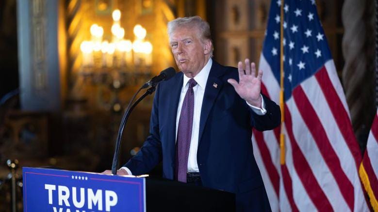 Donald Trump stands at a lecturn in front of two US flags as he speaks to members of the media during a press conference at his Mar-a-Lago Club in Florida Donald Trump stands at a lecturn in front of two US flags as he speaks to members of the media during a press conference at his Mar-a-Lago Club in Florida