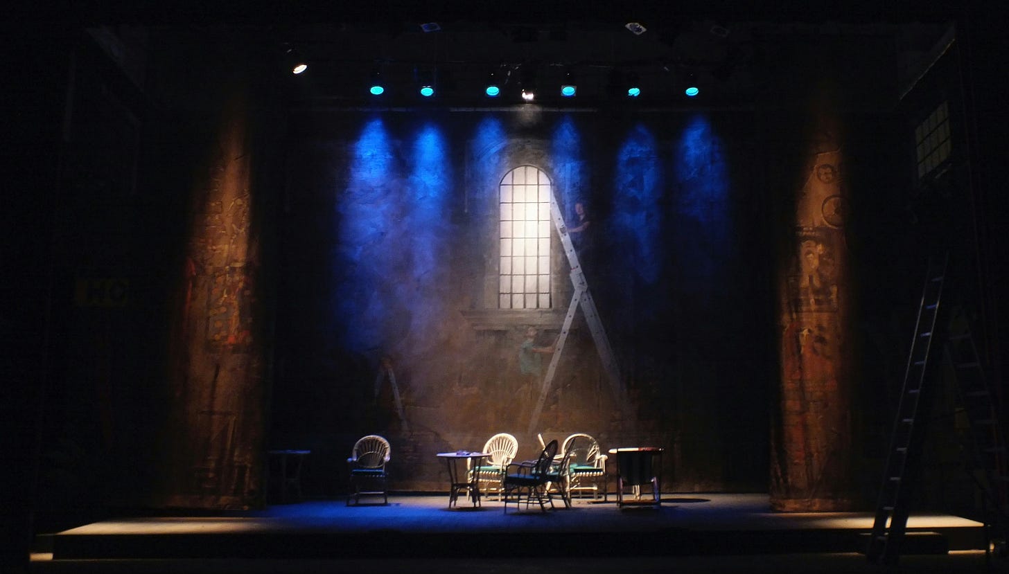 An empty theatre stage, made creepy with mist and dark lighting.