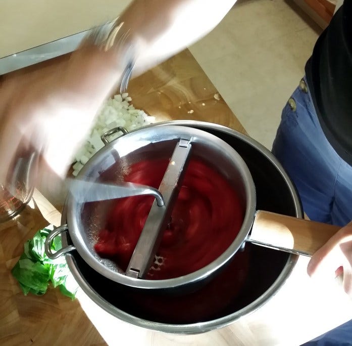 running tomatoes through food mill