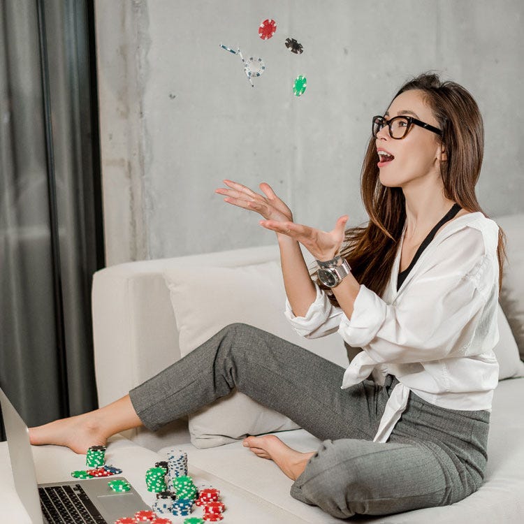 Woman with poker chips and laptop representing writing without worrying about goals.