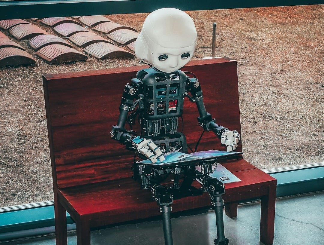 black and white robot toy on red wooden table