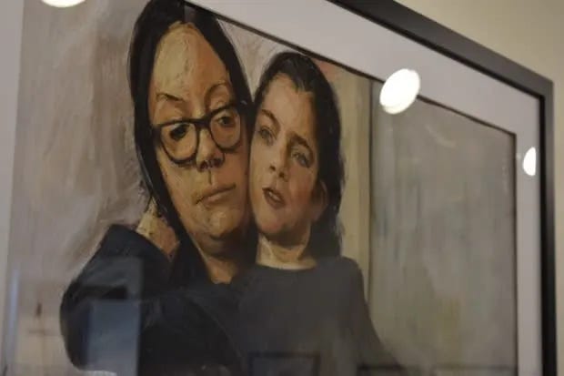 Painting of a mother in glasses, holding her child with epilepsy on her lap. The mom is looking at the child, while the child, their back to mom's chest and right arm reaching back around the mother's neck, is looking to the distance.