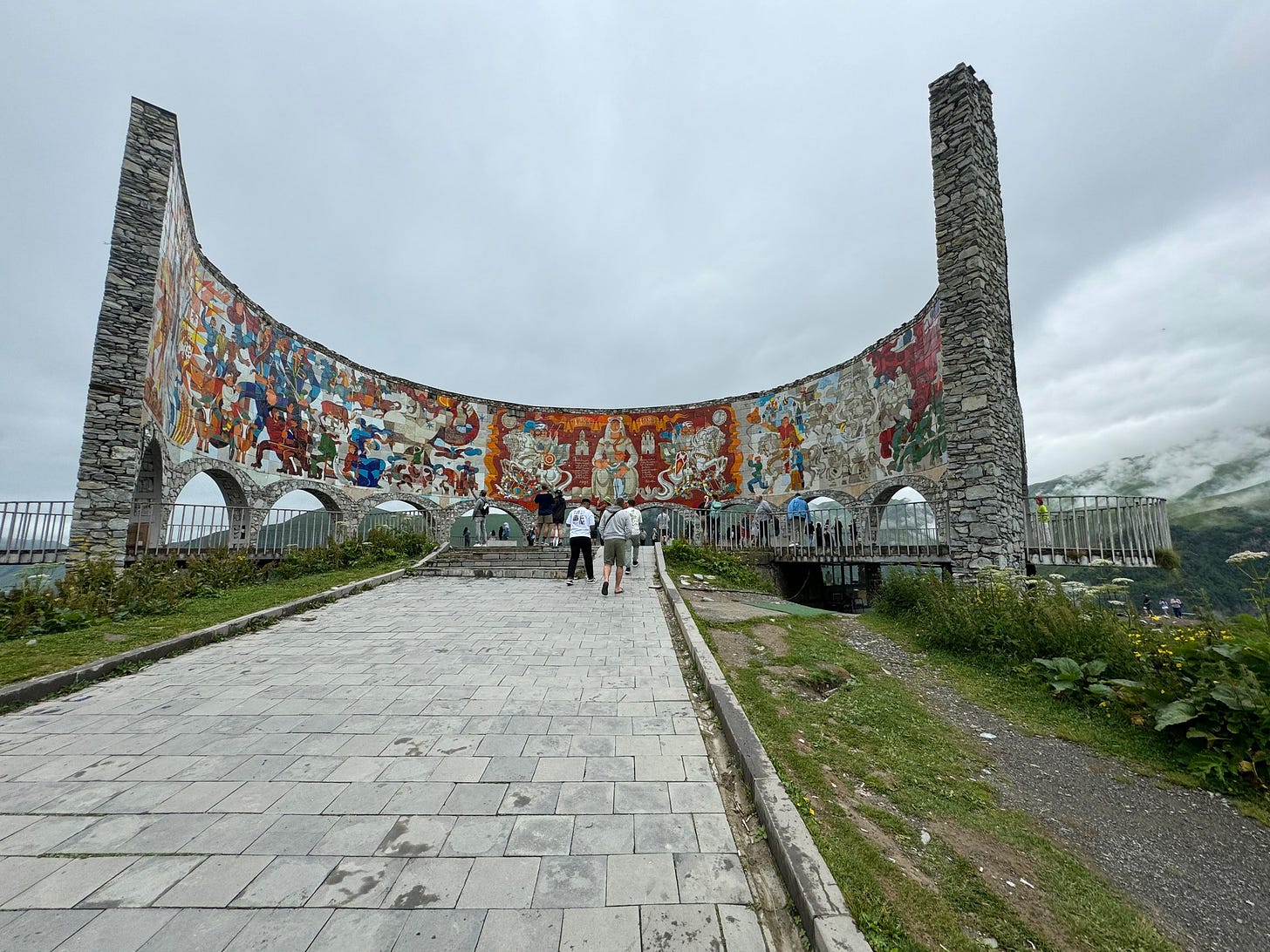 May be an image of 3 people and monument