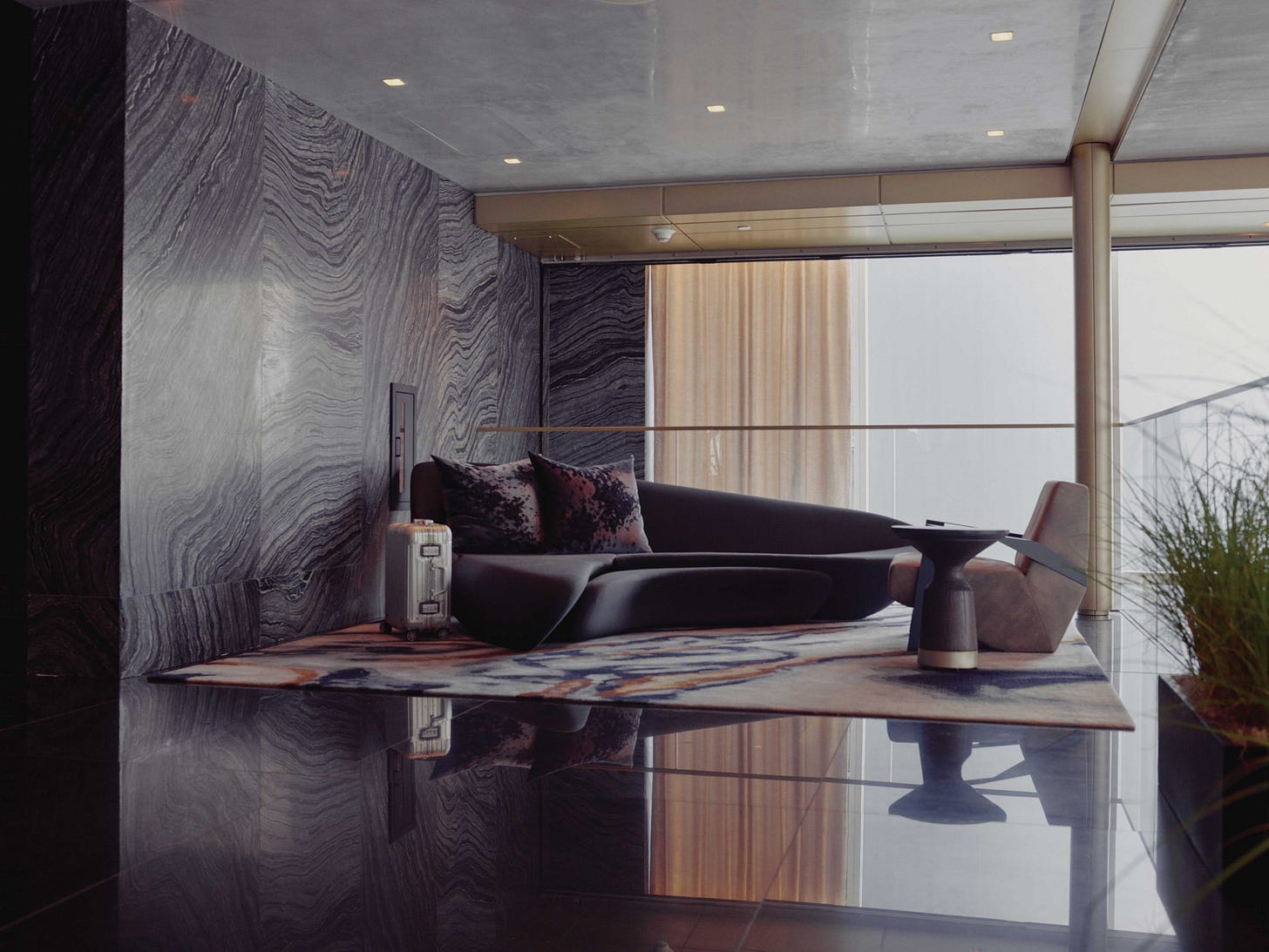 sky lobby reception lounge seating area with suitcase