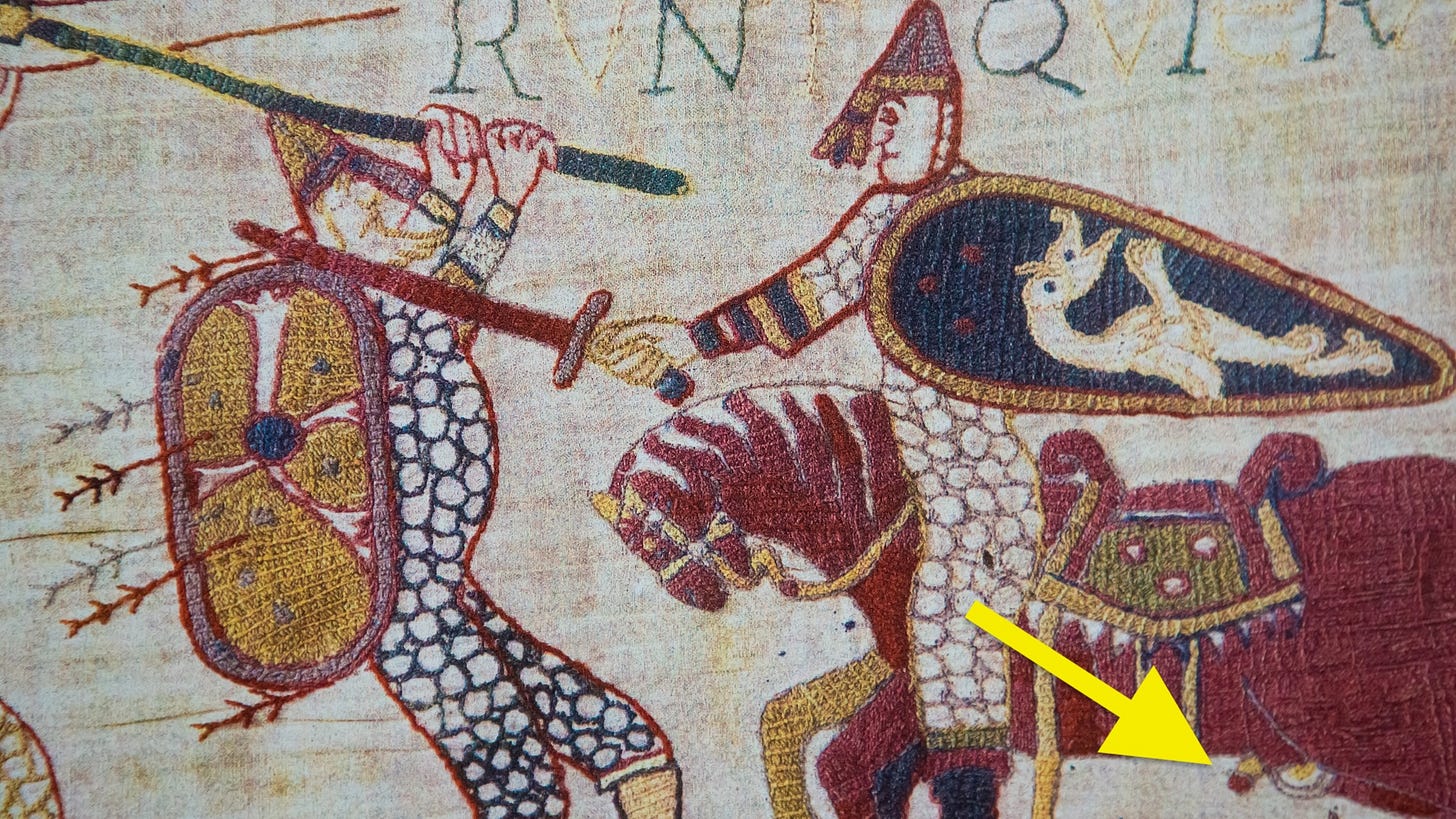 Beyeaux tapestry section depiction horseman and soldier fighting with yellow arrow highlighting horse's penis