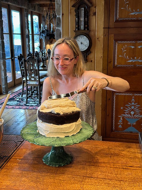 A slice of cake on a plate, frosting a cake, a cake on a plate outdoors