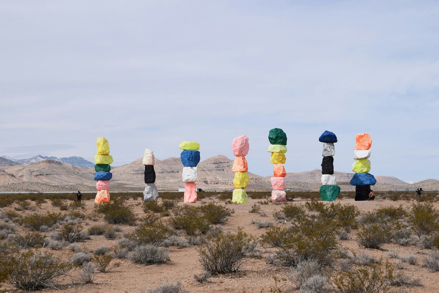 Seven towers of stacked, colorful rocks