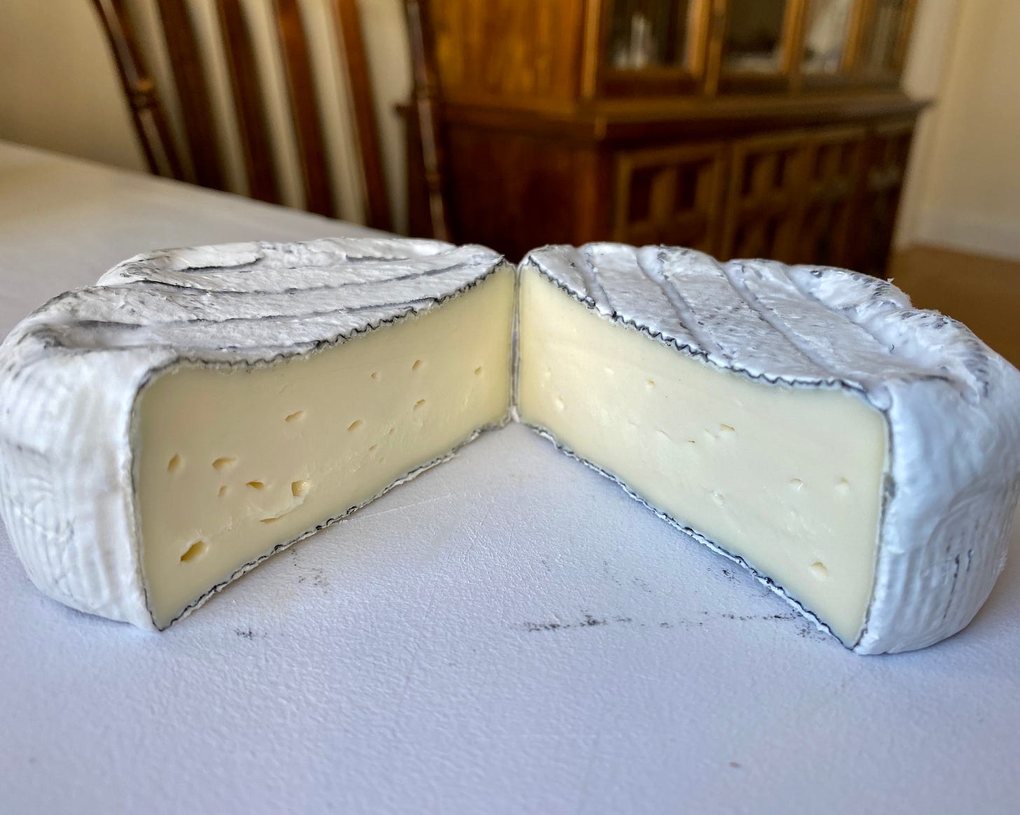 Wheel of Dorothy's Cheese Keep Dreaming cut in half, exposing the cheese interior 