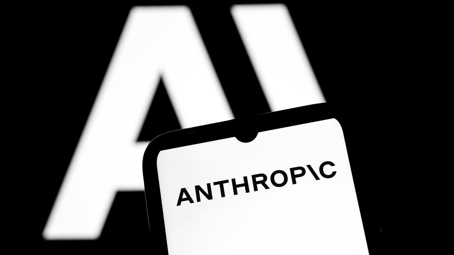 The Anthropic logo appears on a smartphone screen and as the background on a laptop computer screen in this photo illustration in Athens, Greece, on November 12, 2025. Anthropic PBC plans to spend $50 billion to build custom data centers for artificial intelligence work in several US locations, including Texas and New York, as the latest expensive pledge for infrastructure to support the AI boom. (Photo Illustration by Nikolas Kokovlis/NurPhoto via Getty Images)