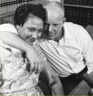 A man with his arm around a woman