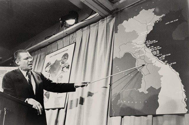 Robert McNamara pointing at a map of Vietnam