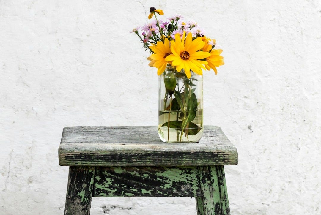 sunflower with clear glass vase on gray table