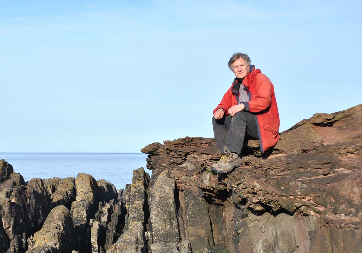 me sitting on rocks at the seaside