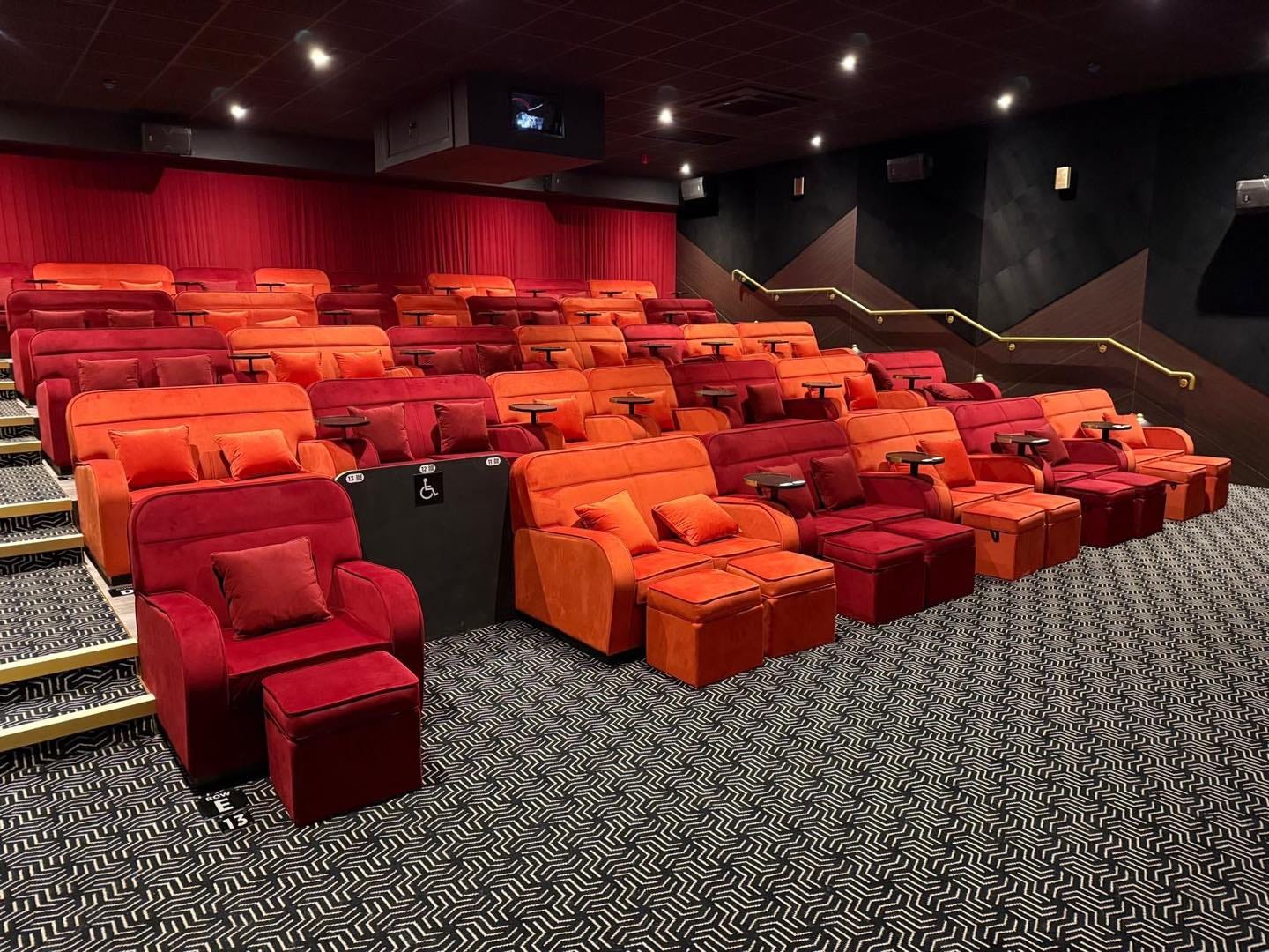 The cinema screen: four rows of velvet-y, red couches and arm chairs fill the cosy screen. In the front row, a gap is available for a wheelchair, but there's enough space at the front for people to access the first row of couches and chairs. 