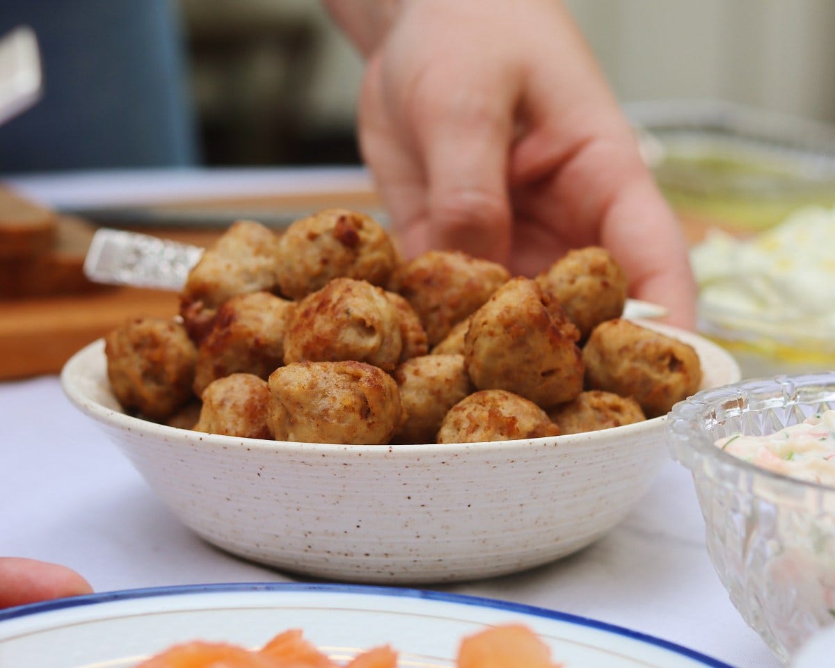 Placing a bowl of meatballs on the table