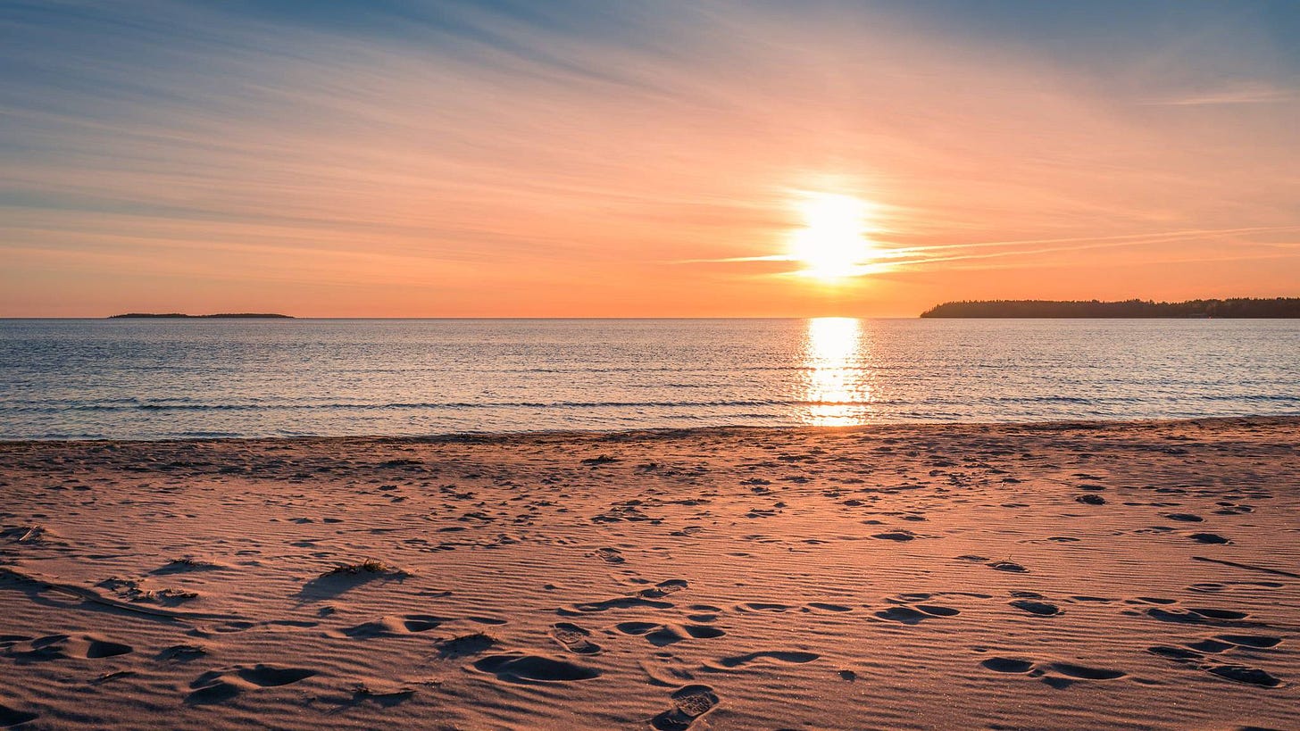 A beach with the sun setting

Description automatically generated with low confidence