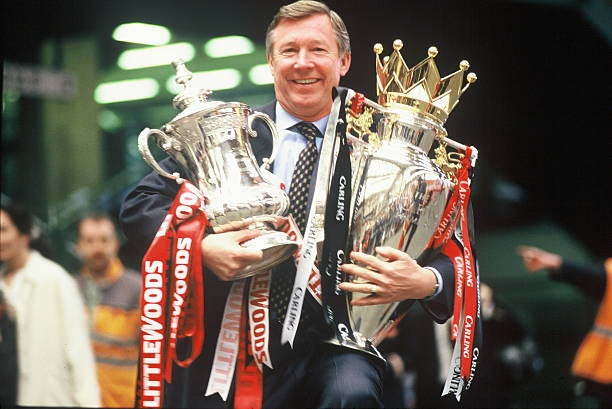 Manager Sir Alex Ferguson of Manchester United with the FA Cup and Premiership Trophy at Victoria Station, Manchester on May 12, 1996 after...