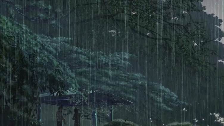 This may contain: the rain is pouring down on some trees