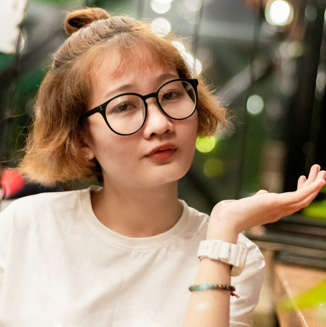 woman in white crew neck shirt wearing black framed eyeglasses