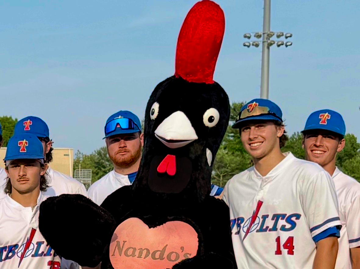 Barci, a friendly black and red cockerel, Nando's official mascot, with the TBolts