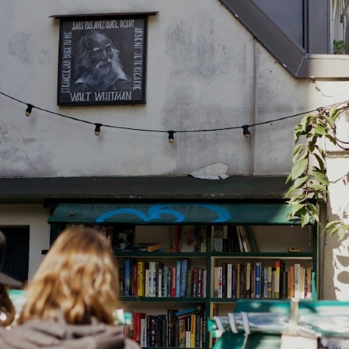 a person looking at a book shelf