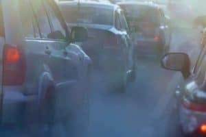 pollution from the exhaust of cars in the city in the winter. Smoke from cars on a cold winter day