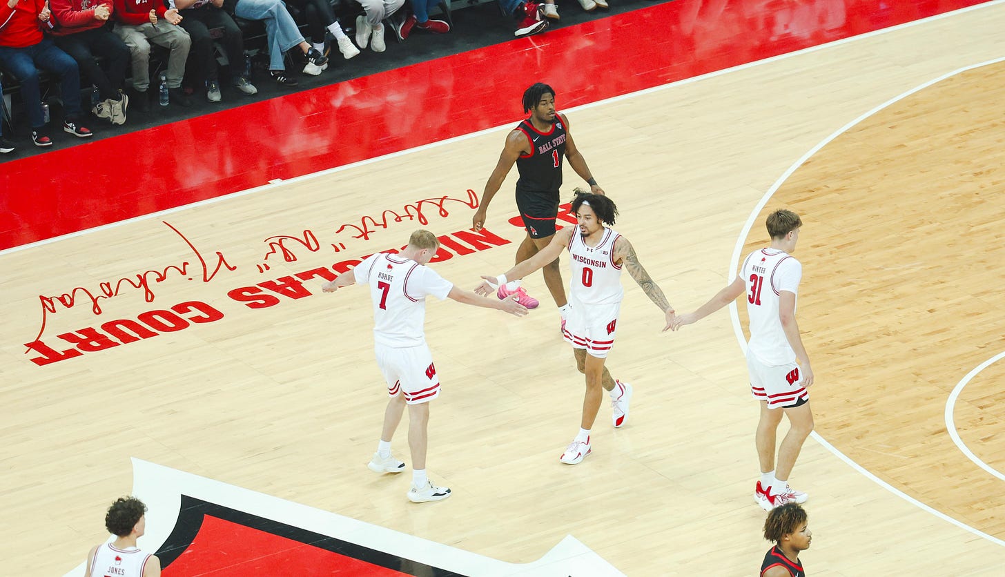 Wisconsin Badgers guards Andrew Rohde and Braeden Carrington, alongside forward Nolan Winter, on the Kohl Center court in a game against Ball State.