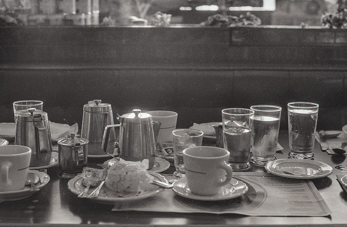 Table of tea pots and glasses of water