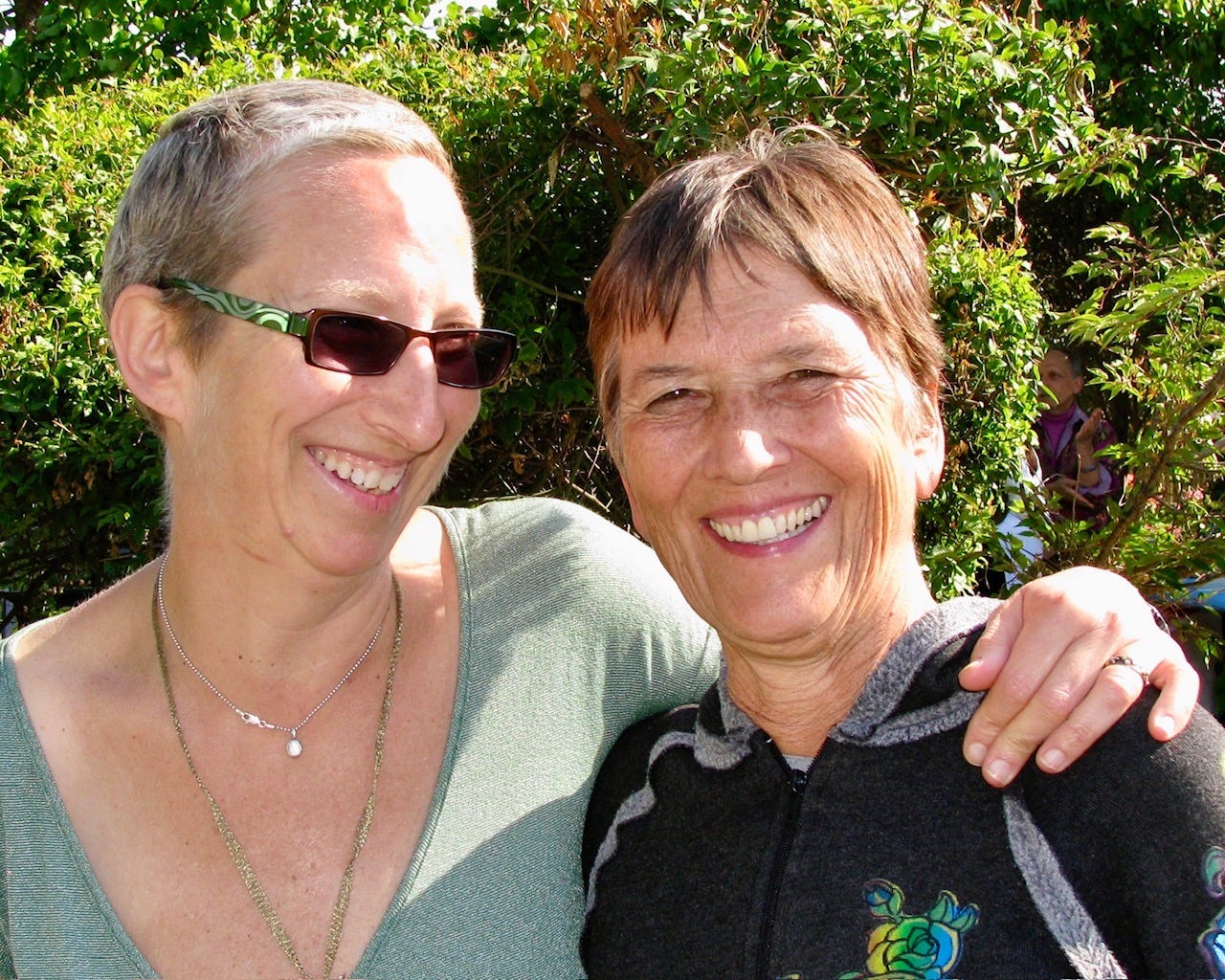 Laura Davis and her wife Karyn Bristol smiling at a party celebrating the end of Laura's breast cancer treatment in 2007