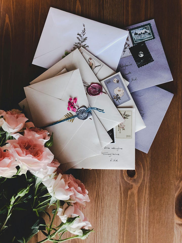 flowers on handwritten letter and pink roses with letters