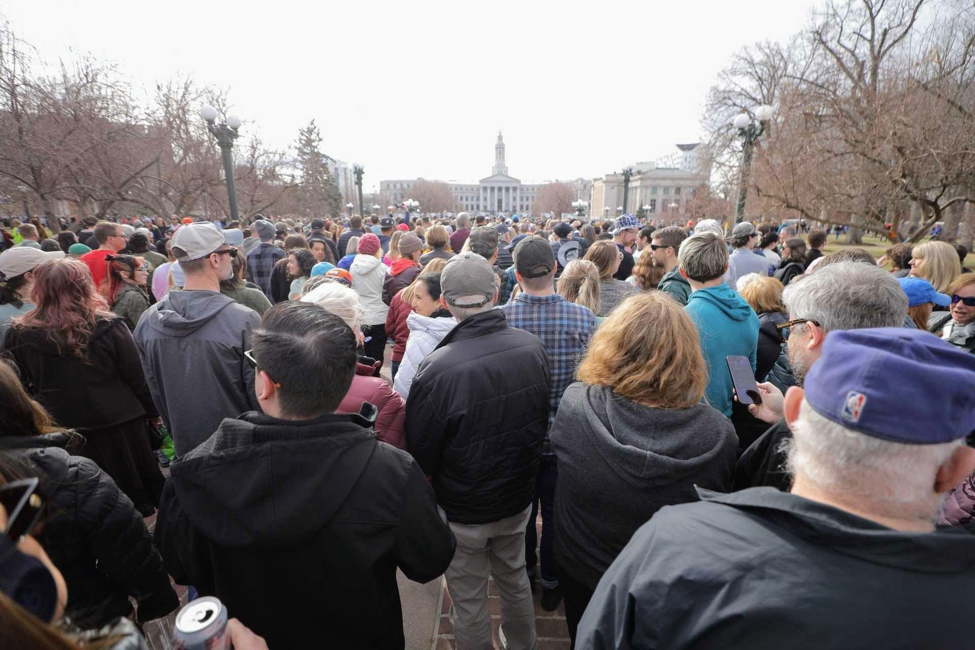 A sea of thousands of people in Civic Center Park. The City and County Building is in the background. A sea of thousands of people in Civic Center Park. The City and County Building is in the background.