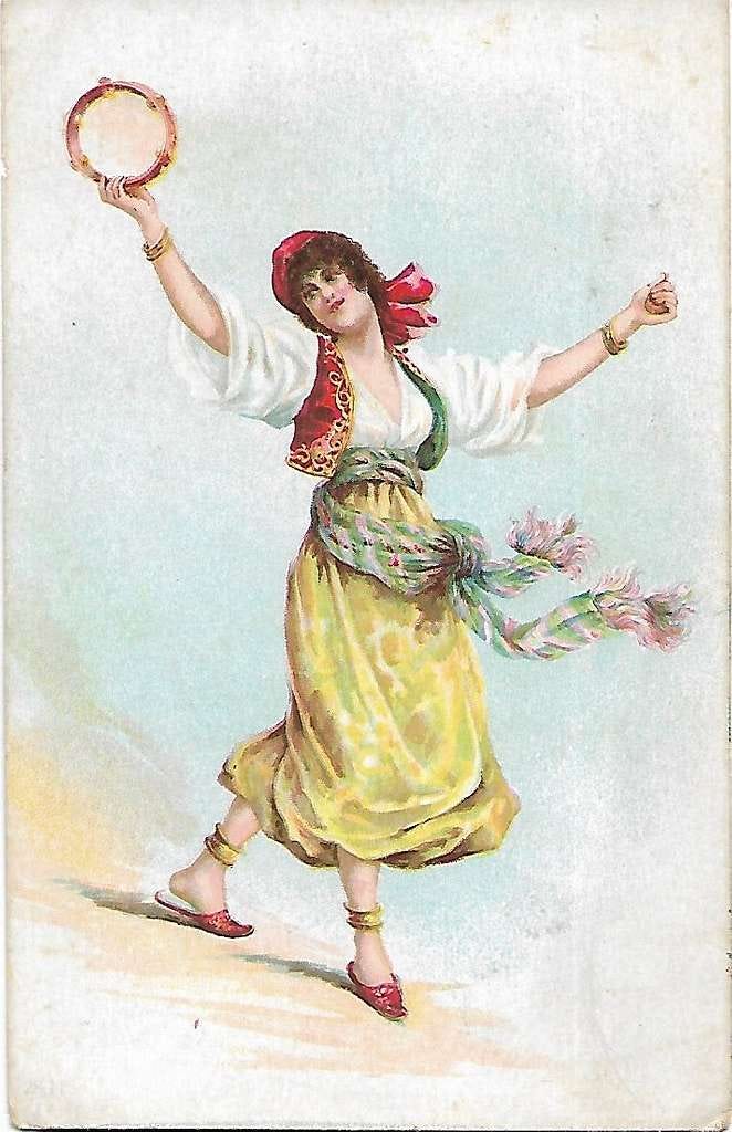 A woman in traditional Southern Italian garb dances with a tamburello in her hand and a slight smile on her face. The tamburello is raised high above her head and her other arm is spread in an open gesture.