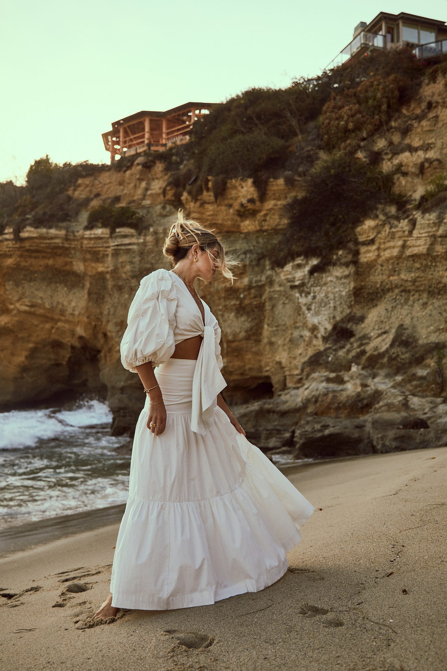a-woman-standing-on-top-of-a-sandy-beach